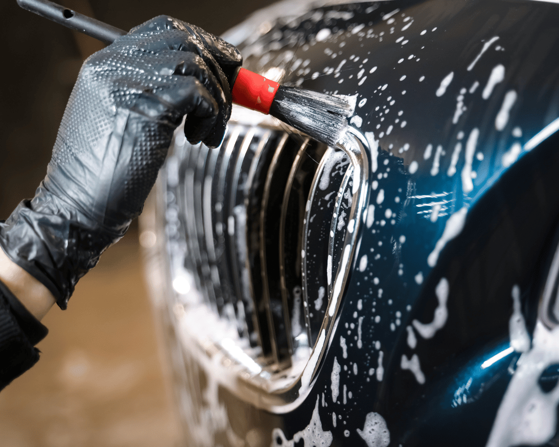 Close-up vehicle detailing work on a clean exterior panel